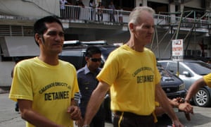 Gerard Peter Scully of Australia (R), accused of raping and trafficking two girls in the Philippines, leaves the court handcuffed to another inmate (L) after his arraignment in Cagayan de Oro City, on the southern Philippine island of Mindanao on June 16, 2015.