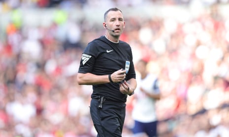 Chris Kavanagh leads the team of match officials at the Emirates Stadium.