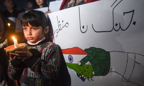 A Pakistani girl holds a light candle during a vigil for peace in Lahore