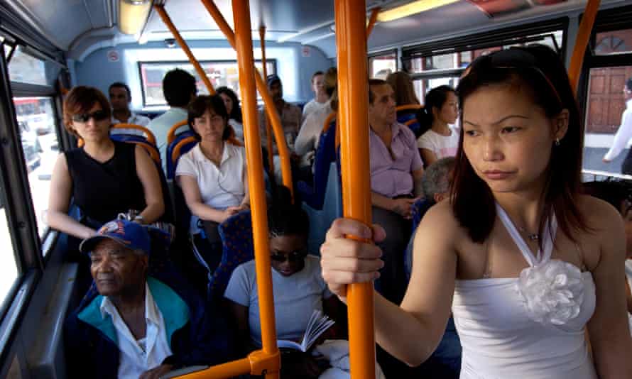 Bus passengers on the crowded lower deck of a number 30 bus