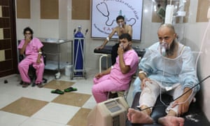 Syrians suffering from breathing difficulties are treated at a makeshift hospital in Aleppo after regime helicopters dropped barrel bombs on the rebel-held Sukkari neighborhood on Tuesday.