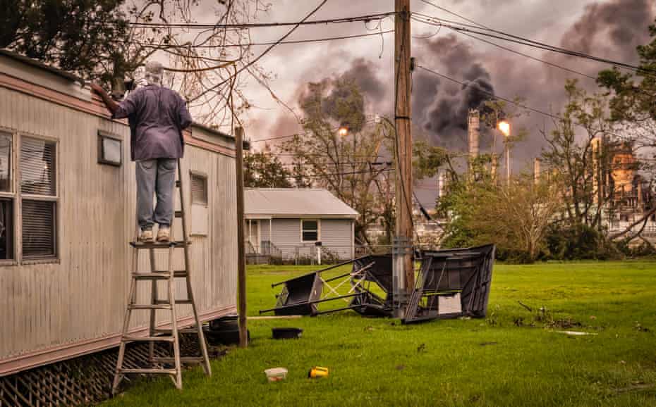 A resident inspects the damage to his home next to Shell's refinery and chemical plant on 31 August.