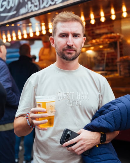West Ham supporter holding a beer in the fan zone
