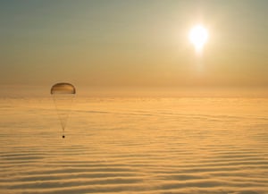 The Soyuz TMA-14M capsule with ISS crew members Barry Wilmore of the U.S., Alexander Samokutyaev and Elena Serova of Russia is seen above clouds as it descends before landing southeast of DzhezkazganThe Soyuz TMA-14M capsule with International Space Station (ISS) crew members Barry Wilmore of the U.S., Alexander Samokutyaev and Elena Serova of Russia is seen above clouds as it descends beneath a parachute just before landing southeast of Dzhezkazgan in central Kazakhstan in this March 12, 2015 picture provided by NASA. REUTERS/Bill Ingalls/NASA/Handout via Reuters (KAZAKHSTAN - Tags: SCIENCE TECHNOLOGY POLITICS TPX IMAGES OF THE DAY) ATTENTION EDITORS - THIS PICTURE WAS PROVIDED BY A THIRD PARTY. REUTERS IS UNABLE TO INDEPENDENTLY VERIFY THE AUTHENTICITY, CONTENT, LOCATION OR DATE OF THIS IMAGE. FOR EDITORIAL USE ONLY. NOT FOR SALE FOR MARKETING OR ADVERTISING CAMPAIGNS. THIS PICTURE IS DISTRIBUTED EXACTLY AS RECEIVED BY REUTERS, AS A SERVICE TO CLIENTS
