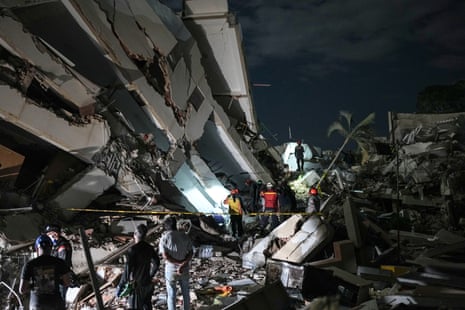 Rescue workers search on Monday through the rubble of a building that collapsed in the earthquakes in La Guaira, Venezuela.