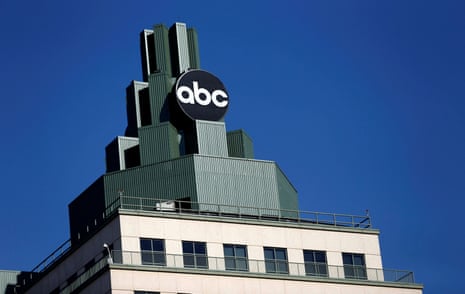 A round ABC logo sits atop a tiered green building in Burbank against a clear blue sky