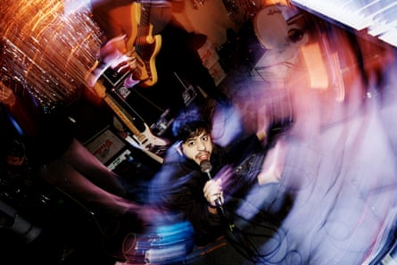 A person singing into a microphone with swirling effects on the image