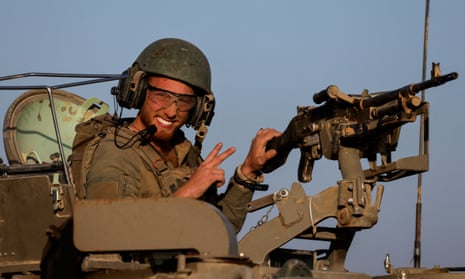 An Israeli soldier in a military vehicle after leaving Gaza during the temporary truce.