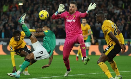 Callum Wilson hooks the ball past Jose Sá to score.