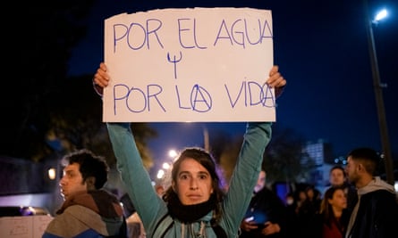 A protester holds a sign that reads ‘For water, for life’ in Montevideo in May.