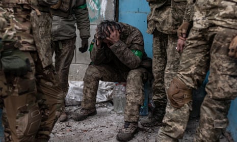 A Ukrainian soldier waits to be transferred to hospital near Bakhmut, Ukraine.