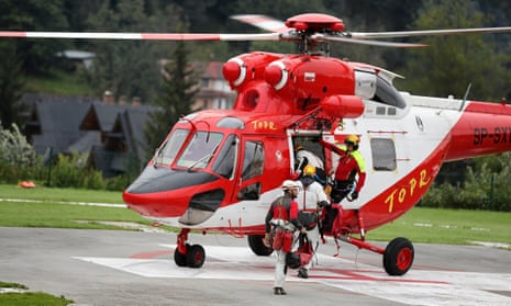 Mountain rescue team members board a helicopter in Zakopane, Poland