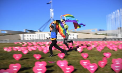 Marriage equality advocate Russell Nankervis (right) and a child run through the ‘Sea of Hearts’ event supporting Marriage Equality outside Parliament House in Canberra, 8 August  2017.