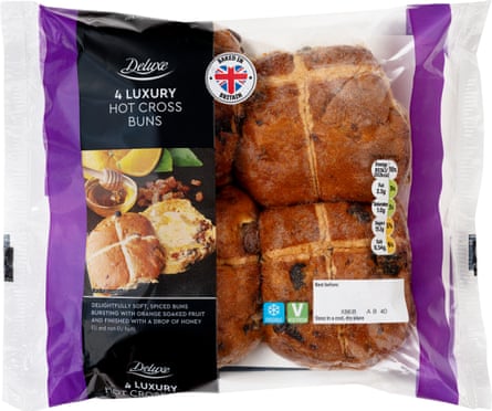 Four Lidl Deluxe hot cross buns in a clear packet with a black and purple label
