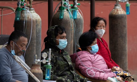 Patients receive oxygen outside a hospital in Kathmandu