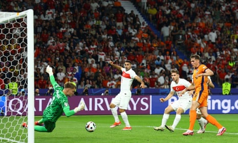 Netherlands' goalkeeper Bart Verbruggen makes a fine save from Turkey's Semih Kılıçsoy.