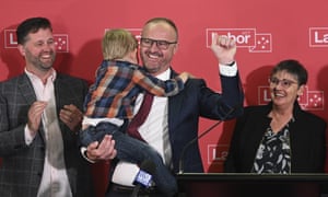 Chief minister Andrew Barr holds his nephew as he celebrates Labor winning its sixth successive election in the ACT.