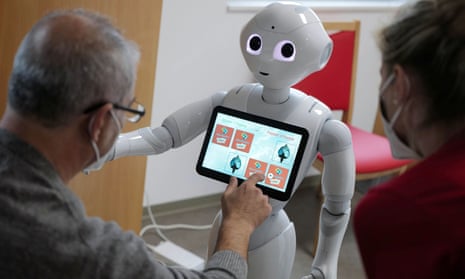 A Pepper robot plays a memory game with a guest at a daycare centre near Frankfurt, Germany, in 2020.