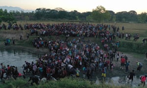 Aerial file photo taken on January 23, 2020 of Central American migrants -mostly Hondurans heading in a caravan to the US - crossing the Suchiate River from Tecun Uman, Guatemala, to Ciudad Hidalgo, Chiapas State, Mexico. - A million Central Americans will have migrated by the end of 2020, mainly due to violence hitting the region, the United Nations High Commissioner for Refugees (UNHCR) reported on December 4, 2020.