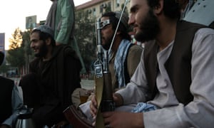 Taliban soldiers talk to each other, in Kabul, Afghanistan, earlier today.