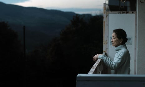 Chieko Baisho as Michi Kakutani stands on a balcony