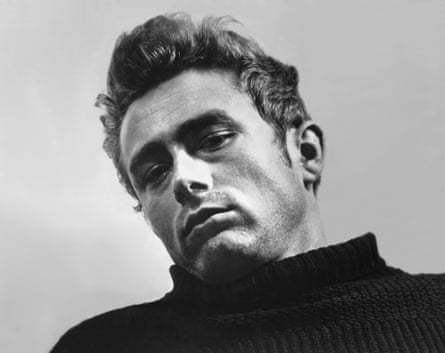James Dean stares at the camera in a black and white shot in 1955.