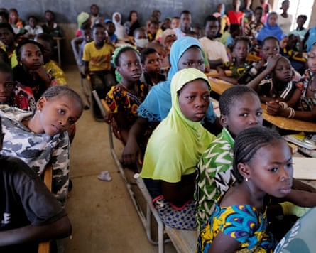 Children sitting in a crowded schoolroom