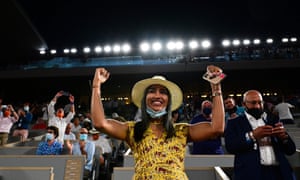 Spectators cheer after the officials announce that curfew hours have been postponed and they can watch the match in its entirety.