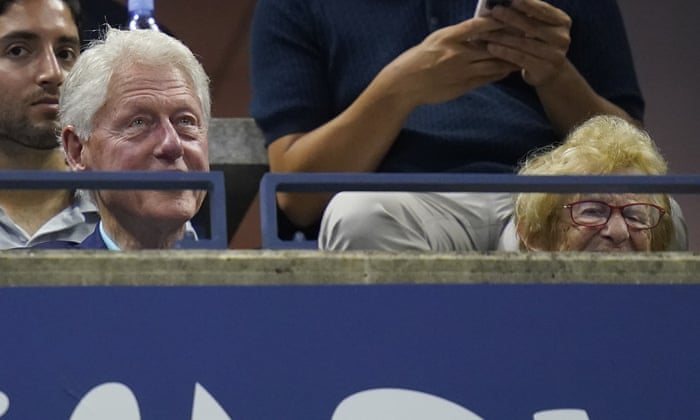 Former President Bill Clinton and Dr. Ruth Westheimer keep their eyes on the action.