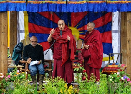 Alan Yentob, left, on stage with the Dalai Lama at the Glastonbury festival in 2015.