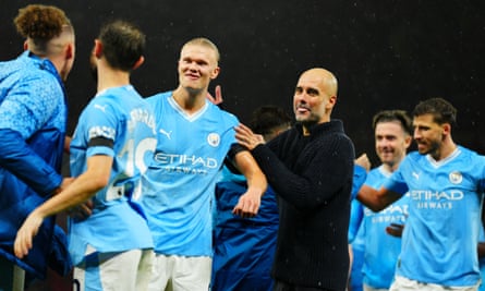 Manchester City manager Pep Guardiola celebrates at full time with Erling Haaland.