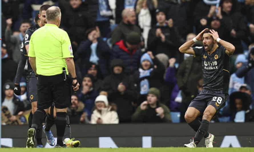João Moutinho looks astonished after referee Jonathan Moss awards the penalty