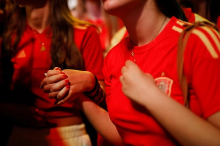 Fans hold hands in the Plaza de Colon.