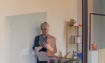 From immediate messaging to dependable wifi: six methods to enhance small enterprise communication | The necessity for pace 1 portrait through a window of a business woman checking work tasks on her Tablet.
