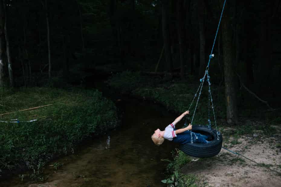 Suffolk, VA -- Braxton Miller, 5, swings near a culvert that connects the historic African American Pughsville neighborhood to the larger drainage system.