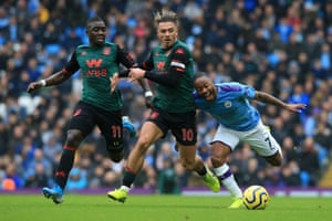 Manchester City’s English midfielder Raheem Sterling tussles with Aston Villa’s English midfielder Jack Grealish.