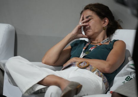 An attendee rests at the COP30 U.N. Climate Summit, Friday, Nov. 21, 2025, in Belem, Brazil. (AP Photo/Fernando Llano)