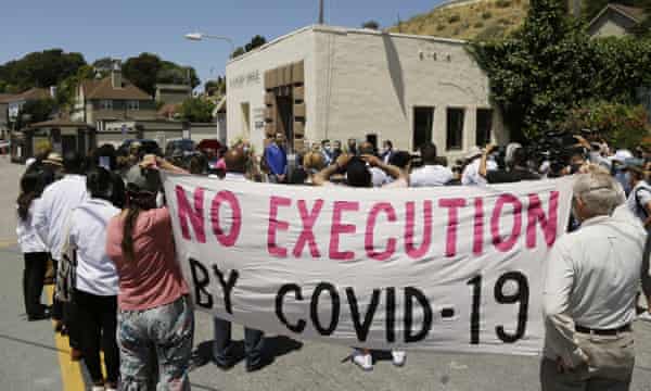 People listen to a news conference outside San Quentin state prison in California on 9 July. Daniel Ruiz, who was housed at San Quentin, died on 11 July.