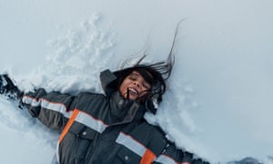Young child lying in the snow