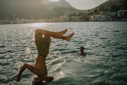 Person somersaulting into the sea.