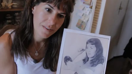 a woman holding a picture of another woman