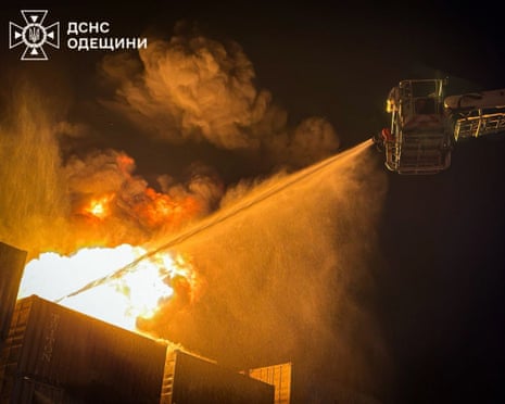 Firefighters spraying water on to a fire from a crane
