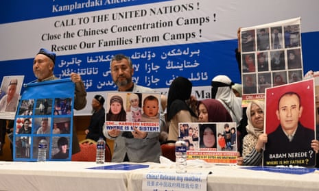 Members of the Uyghur community hold pictures of their relatives detained in China, during a press conference in Istanbul, Turkey.