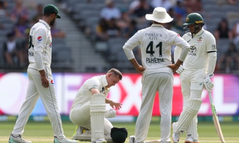 Marnus Labuschagne waits for treatment after being struck by Khurram Shahzad.