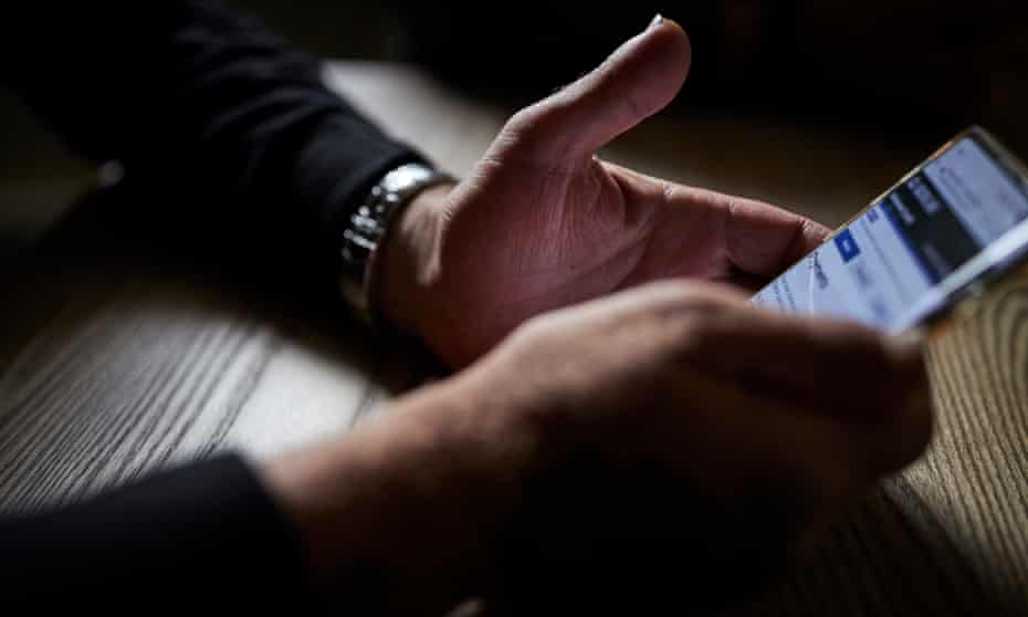 Close-up of man's hands with smartphone
