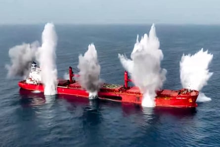 Explosions on a large red bulk carrier at sea