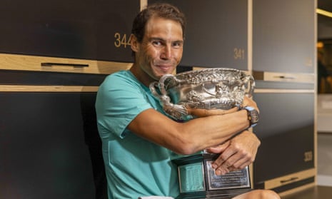Rafael Nadal poses with the Australian Open trophy in the locker room after winning it for a second time, 13 years after his first.