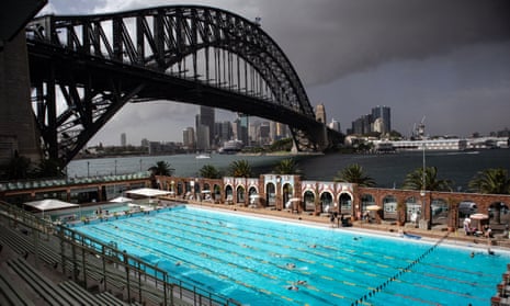A blanket of dust is seen looming over North Sydney Olympic Pool and the Sydney Harbour Bridge on Thursday morning. 