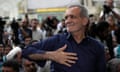 Masoud Pezeshkian greets his supporters in Tehran a day after the presidential election.