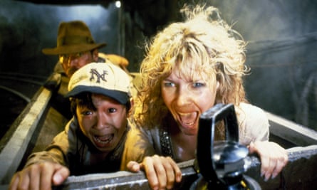 film still of people screaming and clinging on to edge of mine cart